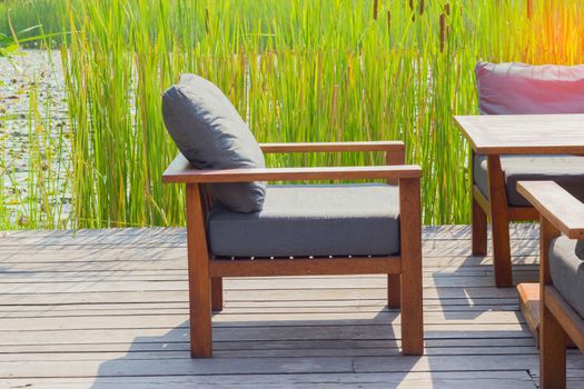 close-up modern chair on wooden floor at coffee shop in Thailand