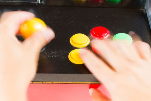 moving hands playing old arcade video game