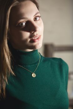 Portrait of beautiful fair young woman with fashion jewelry, one light source