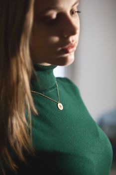 Portrait of beautiful fair young woman with fashion jewelry, one light source