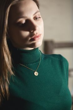 Portrait of beautiful fair young woman with fashion jewelry, one light source