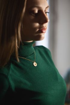 Portrait of beautiful fair young woman with fashion jewelry, one light source