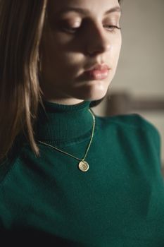 Portrait of beautiful fair young woman with fashion jewelry, one light source