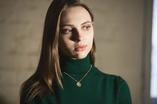 Portrait of beautiful fair young woman with fashion jewelry, one light source