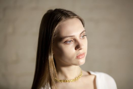 Portrait of beautiful fair young woman with fashion jewelry, one light source