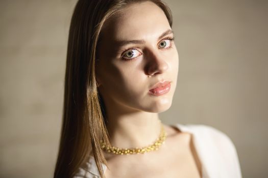 Portrait of beautiful fair young woman with fashion jewelry, one light source