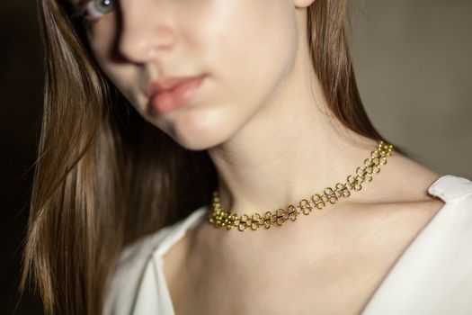Portrait of beautiful fair young woman with fashion jewelry, one light source