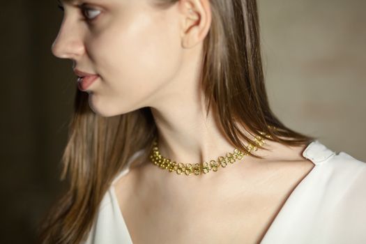 Portrait of beautiful fair young woman with fashion jewelry, one light source