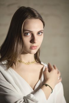 Portrait of beautiful fair young woman with fashion jewelry, one light source