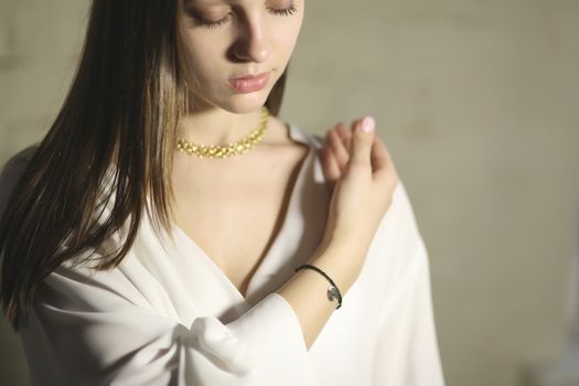 Portrait of beautiful fair young woman with fashion jewelry, one light source