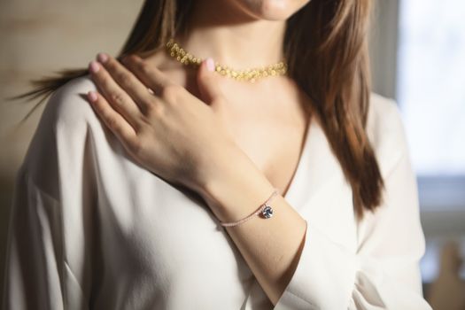 Portrait of beautiful fair young woman with fashion jewelry, one light source