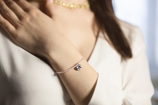 Portrait of beautiful fair young woman with fashion jewelry, one light source