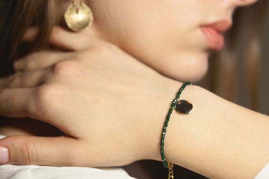 Portrait of beautiful fair young woman with fashion jewelry, one light source