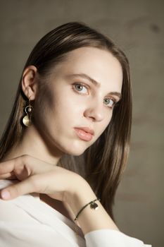 Portrait of beautiful fair young woman with fashion jewelry, one light source