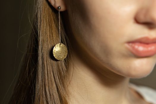 Portrait of beautiful fair young woman with fashion jewelry, one light source