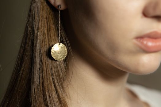Portrait of beautiful fair young woman with fashion jewelry, one light source