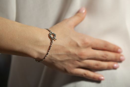 Portrait of beautiful fair young woman with fashion jewelry, one light source