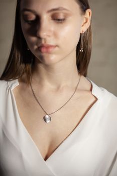 Portrait of beautiful fair young woman with fashion jewelry, one light source