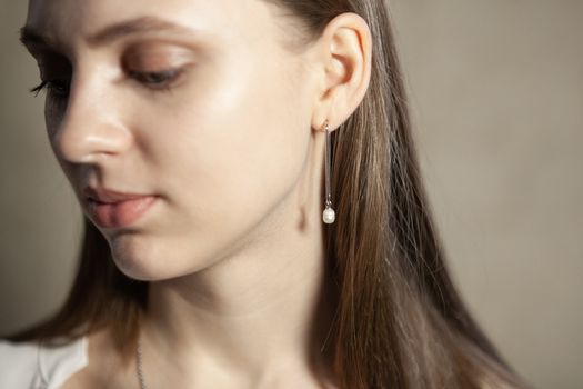 Portrait of beautiful fair young woman with fashion jewelry, one light source
