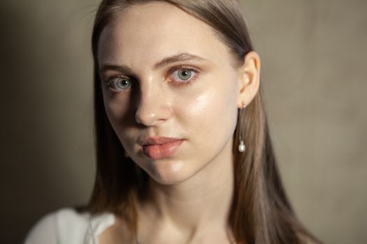 Portrait of beautiful fair young woman with fashion jewelry, one light source