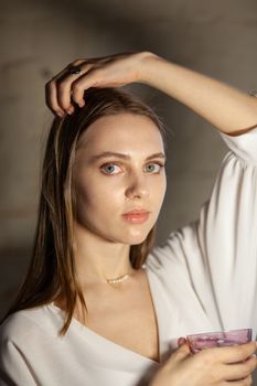 Portrait of beautiful fair young woman with fashion jewelry, one light source