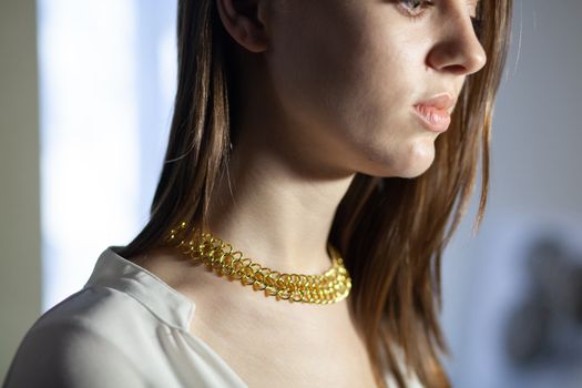 Portrait of beautiful fair young woman with fashion jewelry, one light source