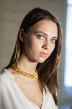 Portrait of beautiful fair young woman with fashion jewelry, one light source