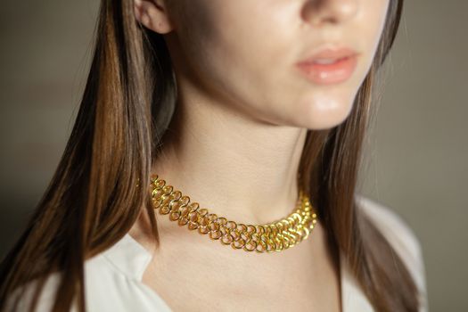 Portrait of beautiful fair young woman with fashion jewelry, one light source