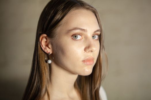 Portrait of beautiful fair young woman with fashion jewelry, one light source