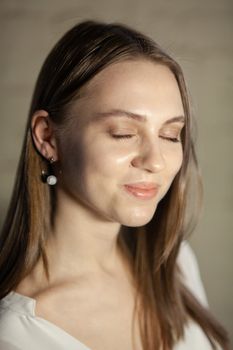Portrait of beautiful fair young woman with fashion jewelry, one light source