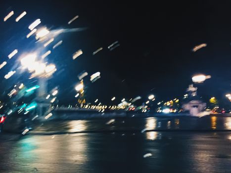 Abstract night city scene in Paris, France, motion blurred lights in the dark