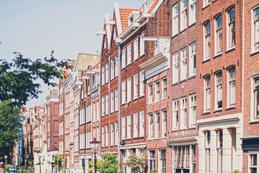 Main downtown street in the city center of Amsterdam in Netherlands on sunny day