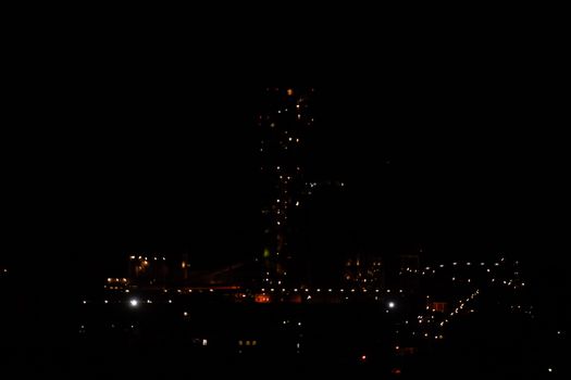 The building of a cement plant at night, the lights of a lamp lighting a factory. Industrial facility.