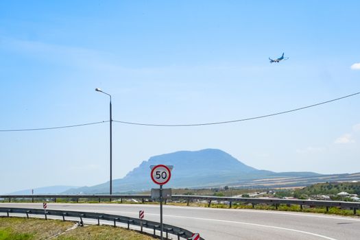 The plane lands over the settlement and the track.