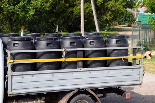 Transportation of chemical agents in plastic barrels on a truck.