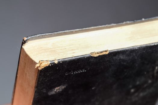 The binding of an old book in black cover.