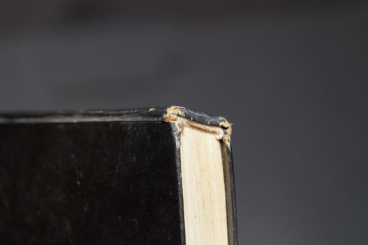The binding of an old book in black cover.
