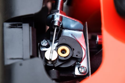 Elements of the fuel system of a gasoline trimmer. Fuel tank and carburetor trimmer engine. Fuel system of a carburetor two-stroke engine. Trimer gascosis with a leaf for mowing grass and shrubs.
