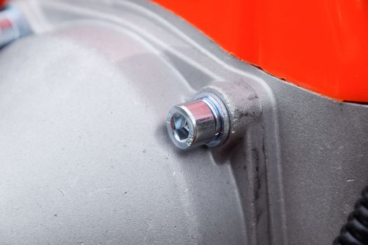 Fasteners for gas trimmer construction. Bolts and screws on the trimer body. Trimer gascosis with a leaf for mowing grass and shrubs.