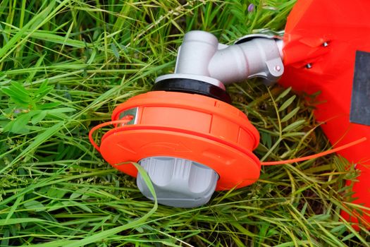 Head with fishing line for mowing grass. Gas trimmer. Trimer gascosis with a leaf for mowing grass and shrubs.
