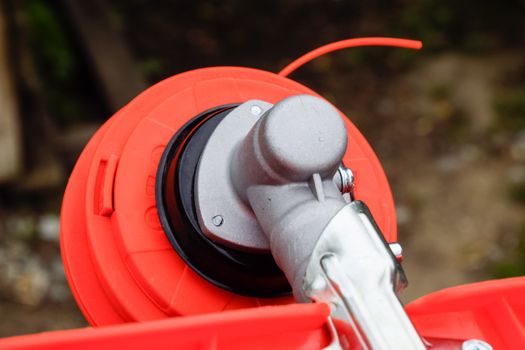 Head with fishing line for mowing grass. Gas trimmer. Trimer gascosis with a leaf for mowing grass and shrubs.