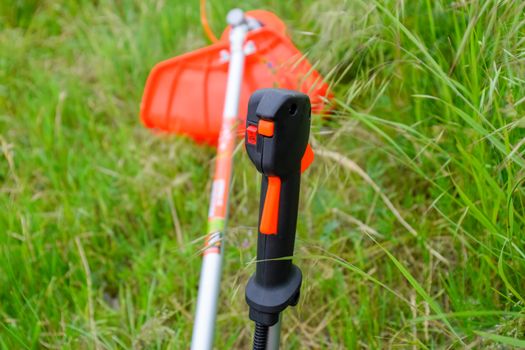 Knob with trimmer controls. Gas trimmer, equipment controls. Trimer gascosis with a leaf for mowing grass and shrubs.