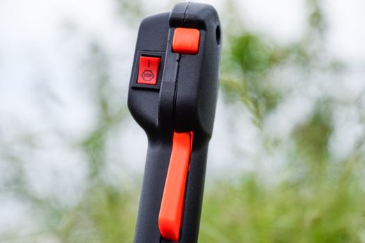 Knob with trimmer controls. Gas trimmer, equipment controls. Trimer gascosis with a leaf for mowing grass and shrubs.