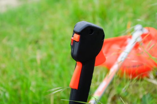 Knob with trimmer controls. Gas trimmer, equipment controls. Trimer gascosis with a leaf for mowing grass and shrubs.