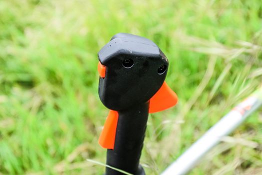 Knob with trimmer controls. Gas trimmer, equipment controls. Trimer gascosis with a leaf for mowing grass and shrubs.