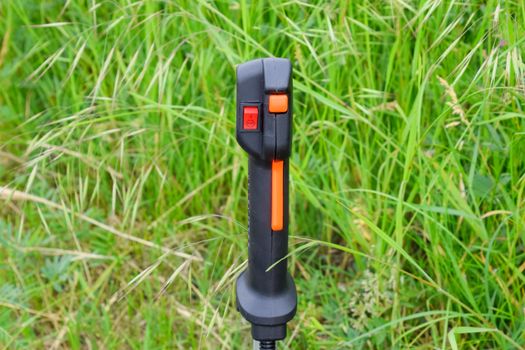Knob with trimmer controls. Gas trimmer, equipment controls. Trimer gascosis with a leaf for mowing grass and shrubs.