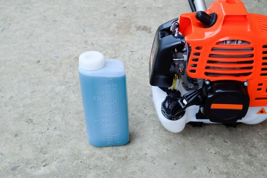 Prepared fuel mixture for a two stroke gasoline trimmer engine. Gasoline trimmer. Trimer gascosis with a leaf for mowing grass and shrubs.