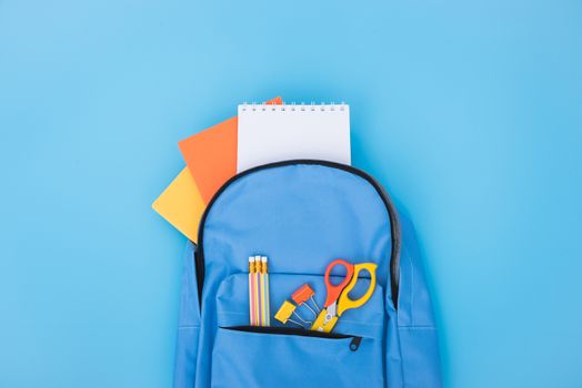 Top view Blue bag backpack for education children on blue background back to school concept