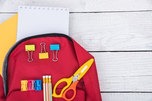 Top view Red bag backpack for education children on white wooden  background back to school concept