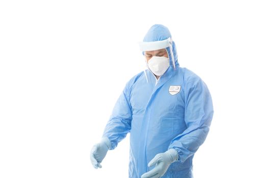 Healthcare or industrial worker wearing a Type 5 & 6 hasmat coverall, maskgloves  and face shield for working with infectious virus pathogens or hazardous material, like asbestos or respiratory viruses like COVID-19 coronavirus